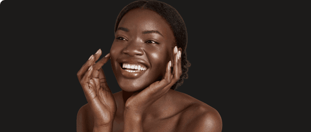 Smiling woman with glowing skin representing face and skin treatments at Be You Esthetic Suites.